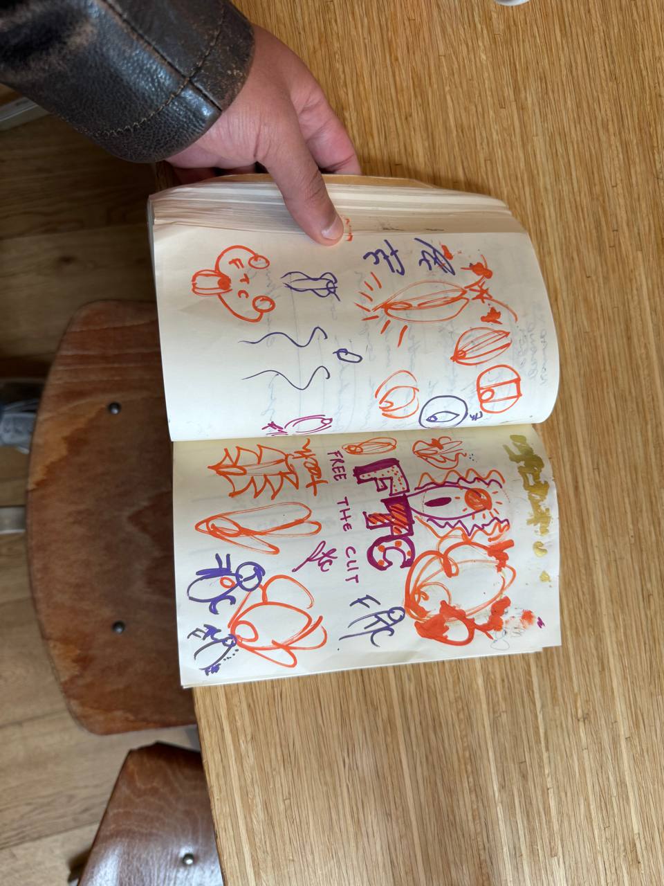 Hand-drawn sketchbook page with marker doodles exploring the project's visual language